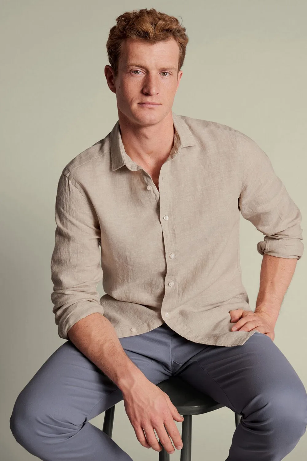 beige linen button-up shirt with rolled sleeves – a breathable summer essential for men in 2025.