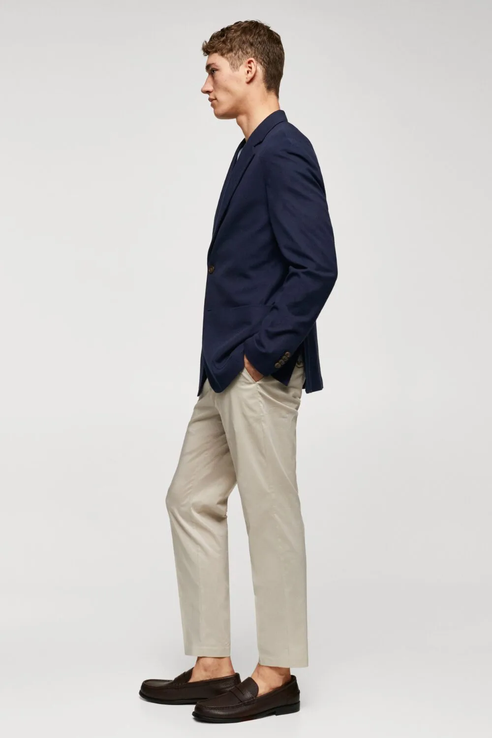 Side view of a navy unstructured linen blazer — lightweight and relaxed, ideal for smart summer layering.