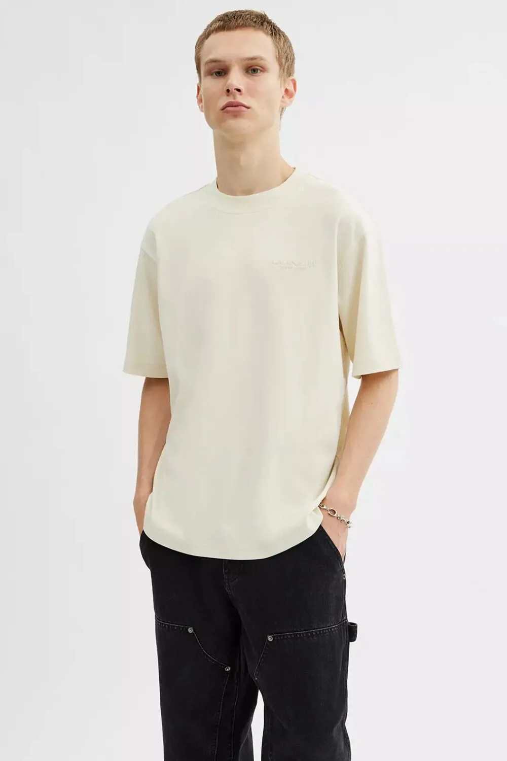 A white knitted cotton tee — your go-to for a cool, casual summer look.