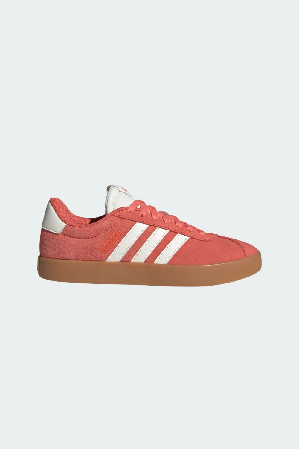Coral Adidas sneakers — a bold pop of color that’s perfect for summer trend-focused looks.