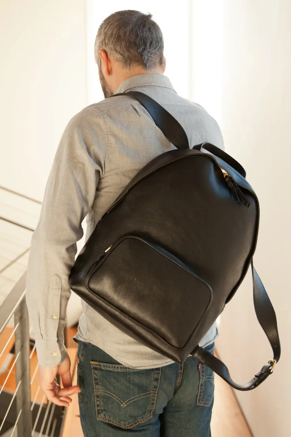 Man wearing Lotuff Leather Zipper Backpack in black