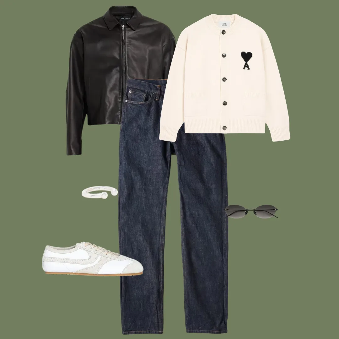 Flat lay of a white crewneck cardigan, cropped black leather jacket, high-waisted jeans, torpedo sneakers, rimless sunglasses, and a silver ring.