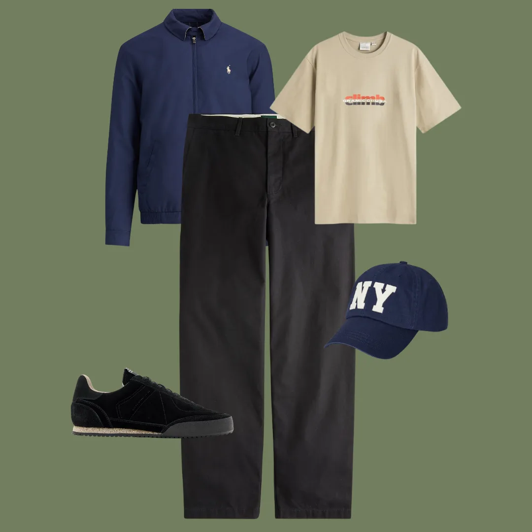Flat lay of a beige T-shirt, navy windbreaker, black chinos, low-top sneakers, and a navy baseball cap