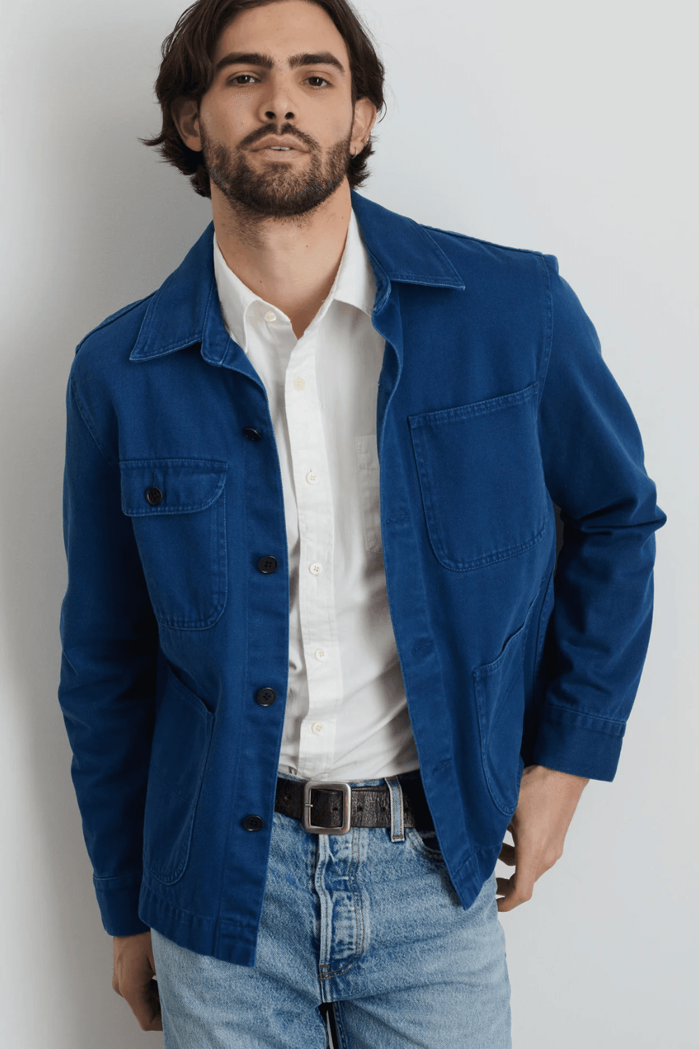 Man wearing Alex Mill Garment Dyed Work Jacket in Recycled Denim