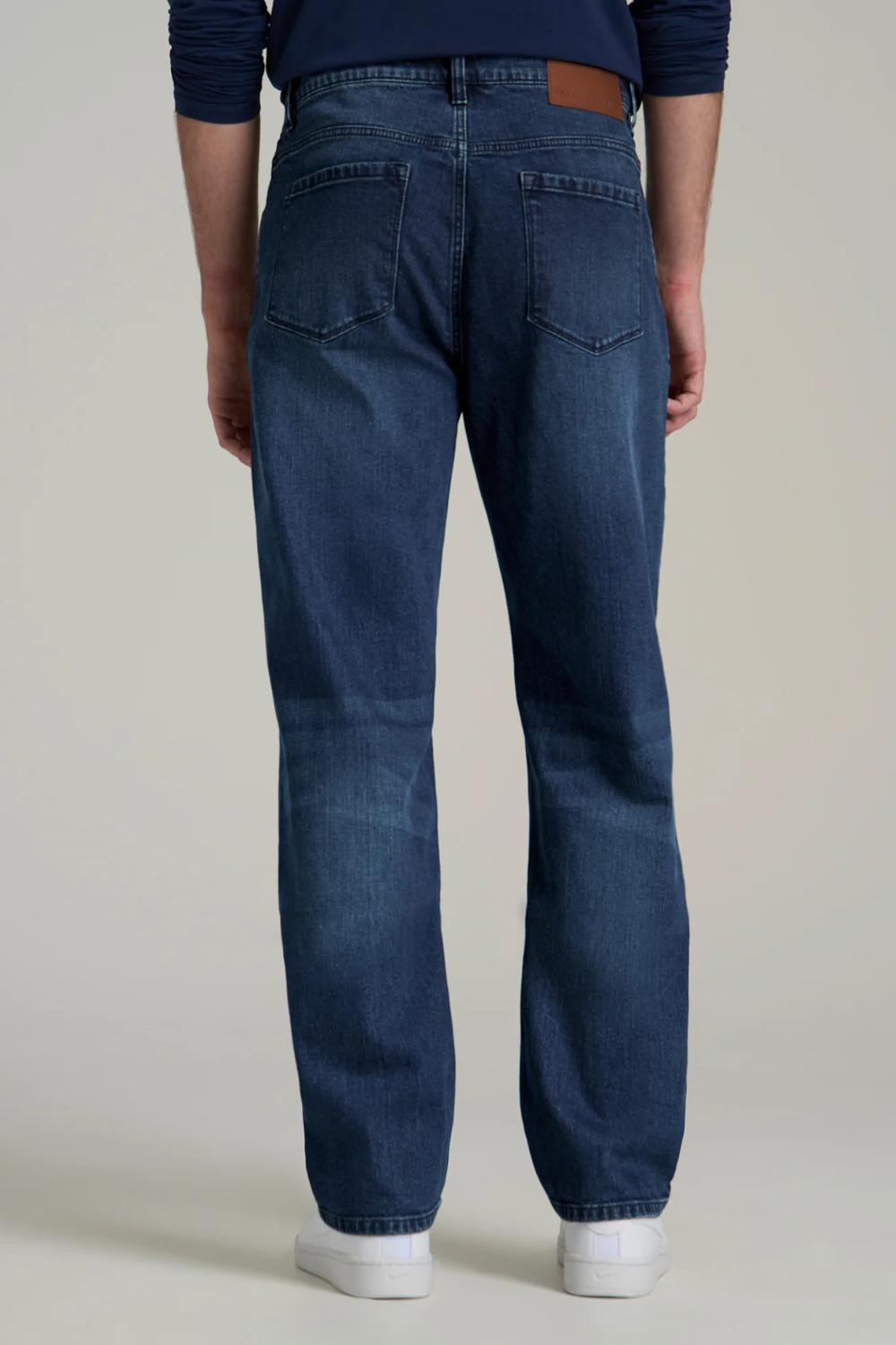 A man wearing American Tall J1 Straight Leg Jeans in Atlantic Blue, shown from the back.