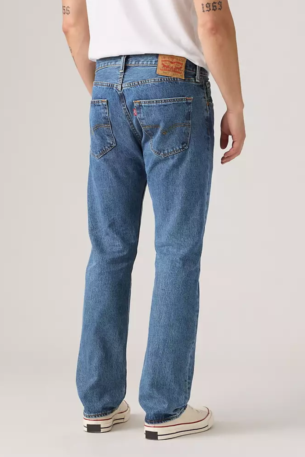 A man wearing Levi’s 501 Original Fit Jeans in Stonewash Blue, shown from the back.