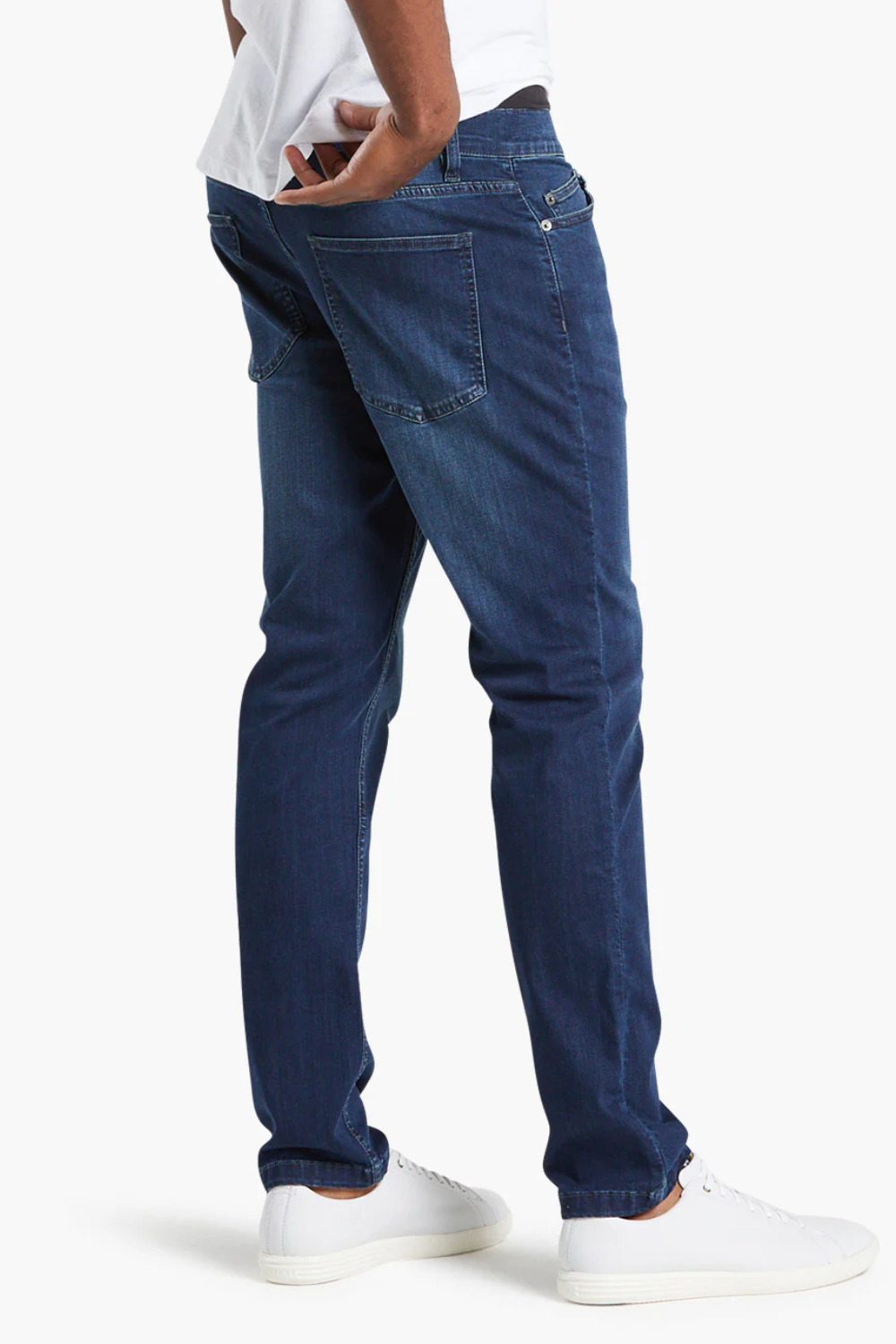A man wearing Mugsy Fulton Stretch Denim Jeans in blue, shown from the back.