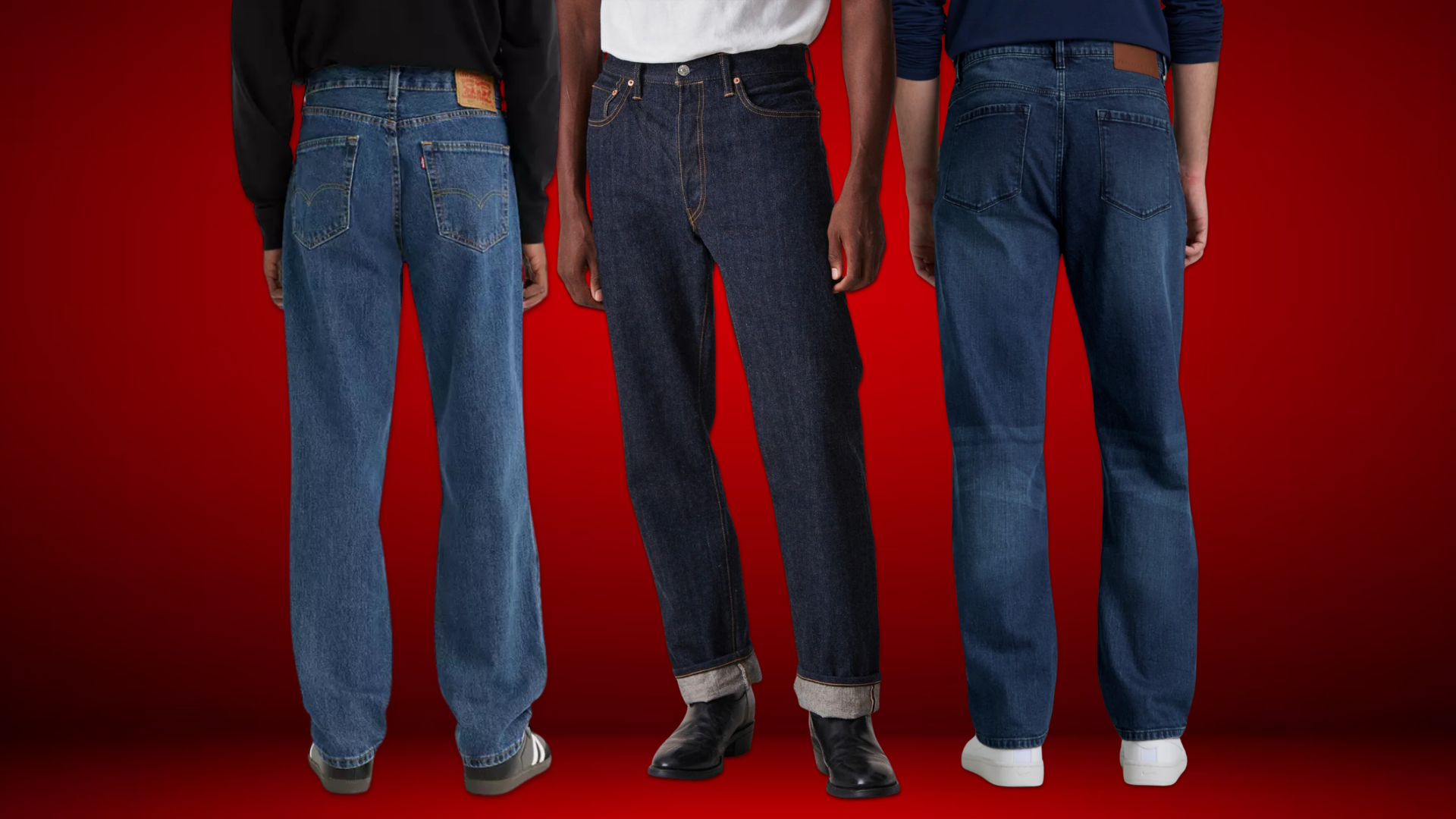 Three men wearing different styles of jeans — vintage blue relaxed fit, raw denim straight leg, and mid-wash regular fit — styled with sneakers and boots against a red background.