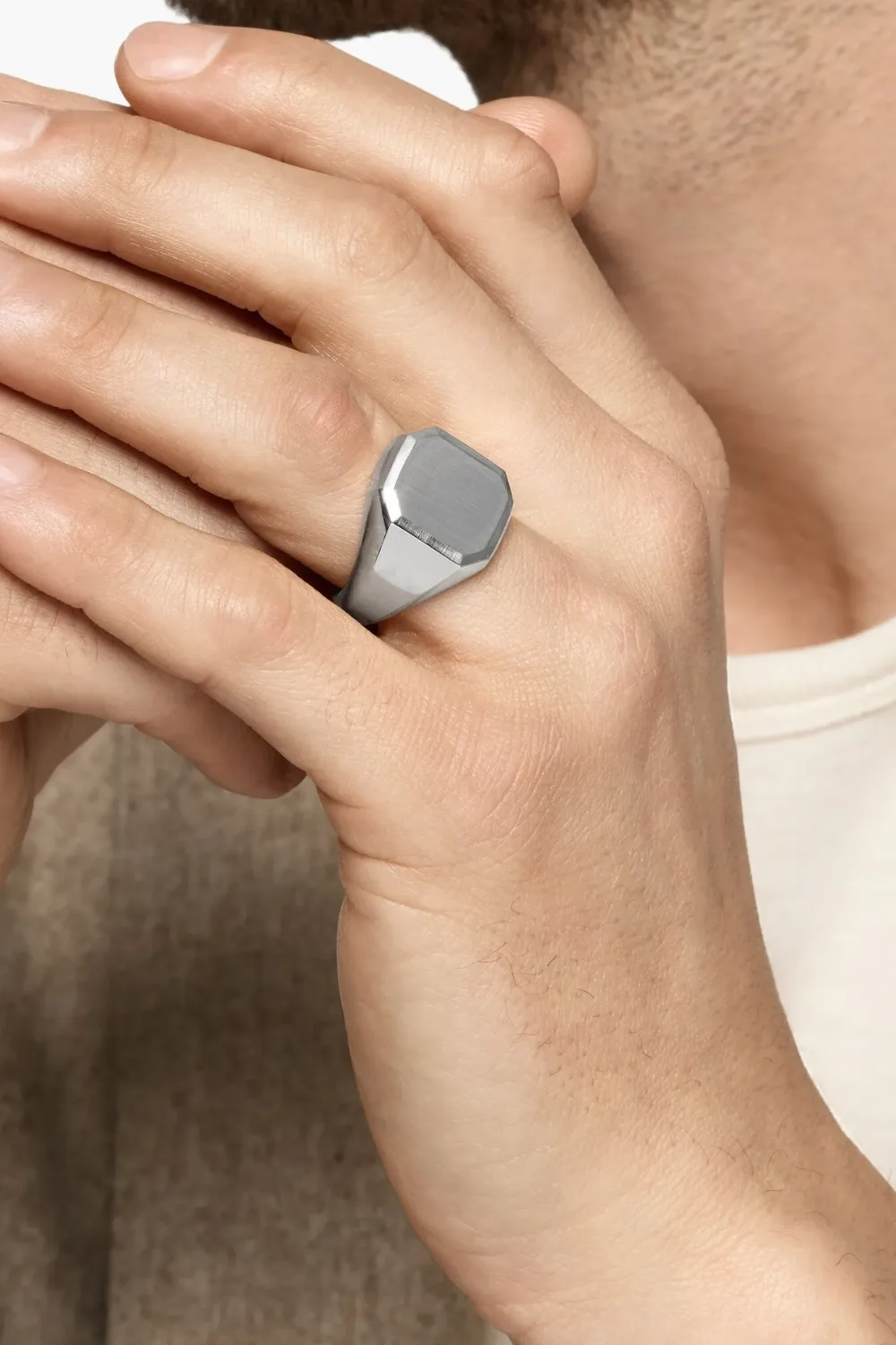 Close-up image of a man’s hand wearing the David Yurman sterling silver Streamline signet ring, showcasing its smooth polished surface and modern streamlined shape.