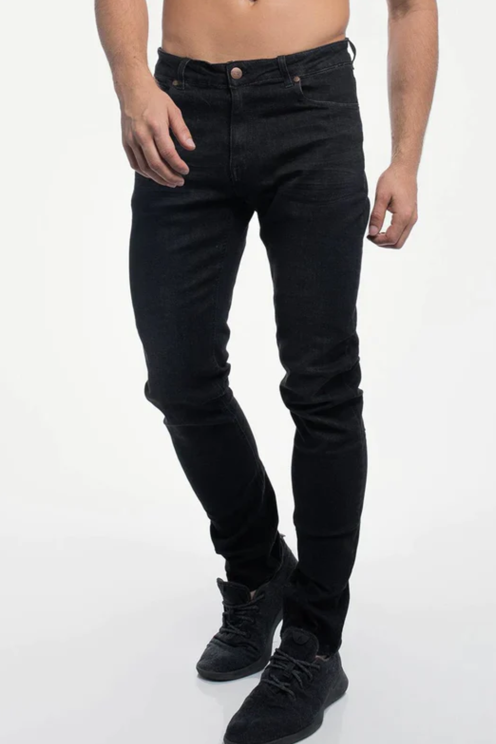 A man wearing Barbell Apparel Straight Athletic Fit Jeans in Black, shown from the front.