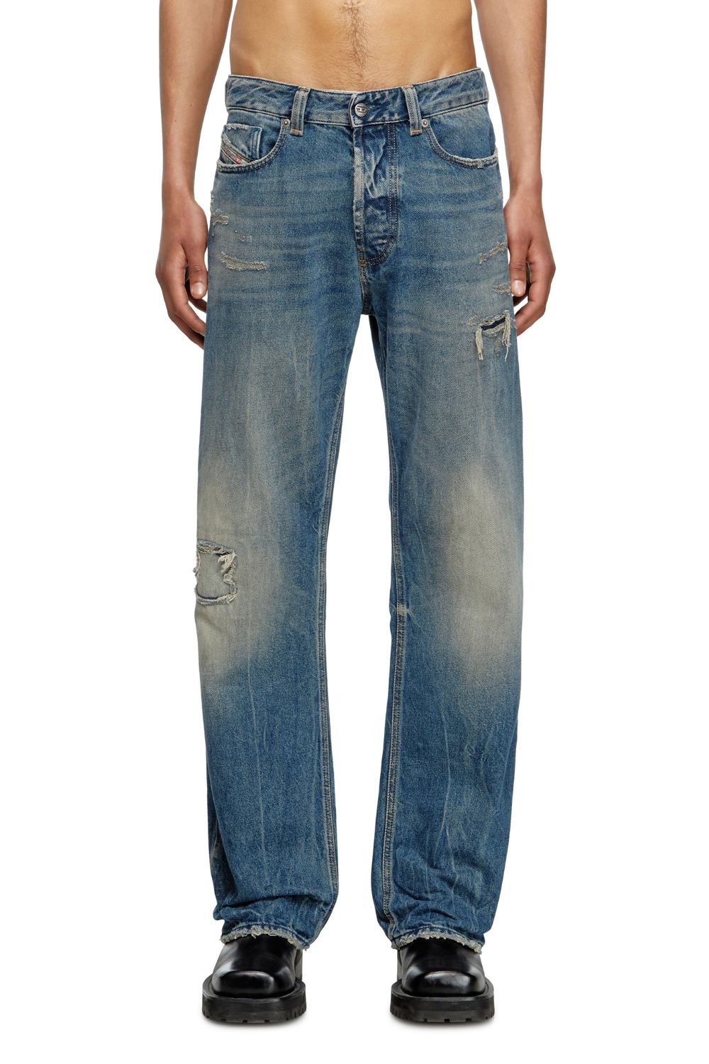 A man wearing Diesel 1980 D-Eepher Distressed Relaxed Jeans in medium blue, shown from the front.