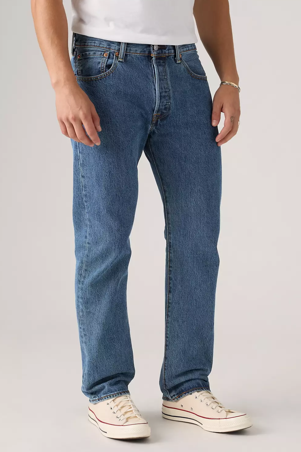 A man wearing Levi’s 501 Original Fit Jeans in Stonewash Blue, shown from the front.