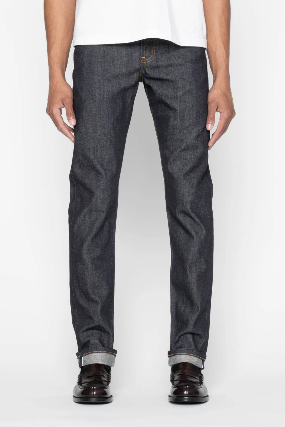 A man wearing Naked & Famous Weird Guy Left-Hand Twill Selvedge Jeans in gray, shown from the front.
