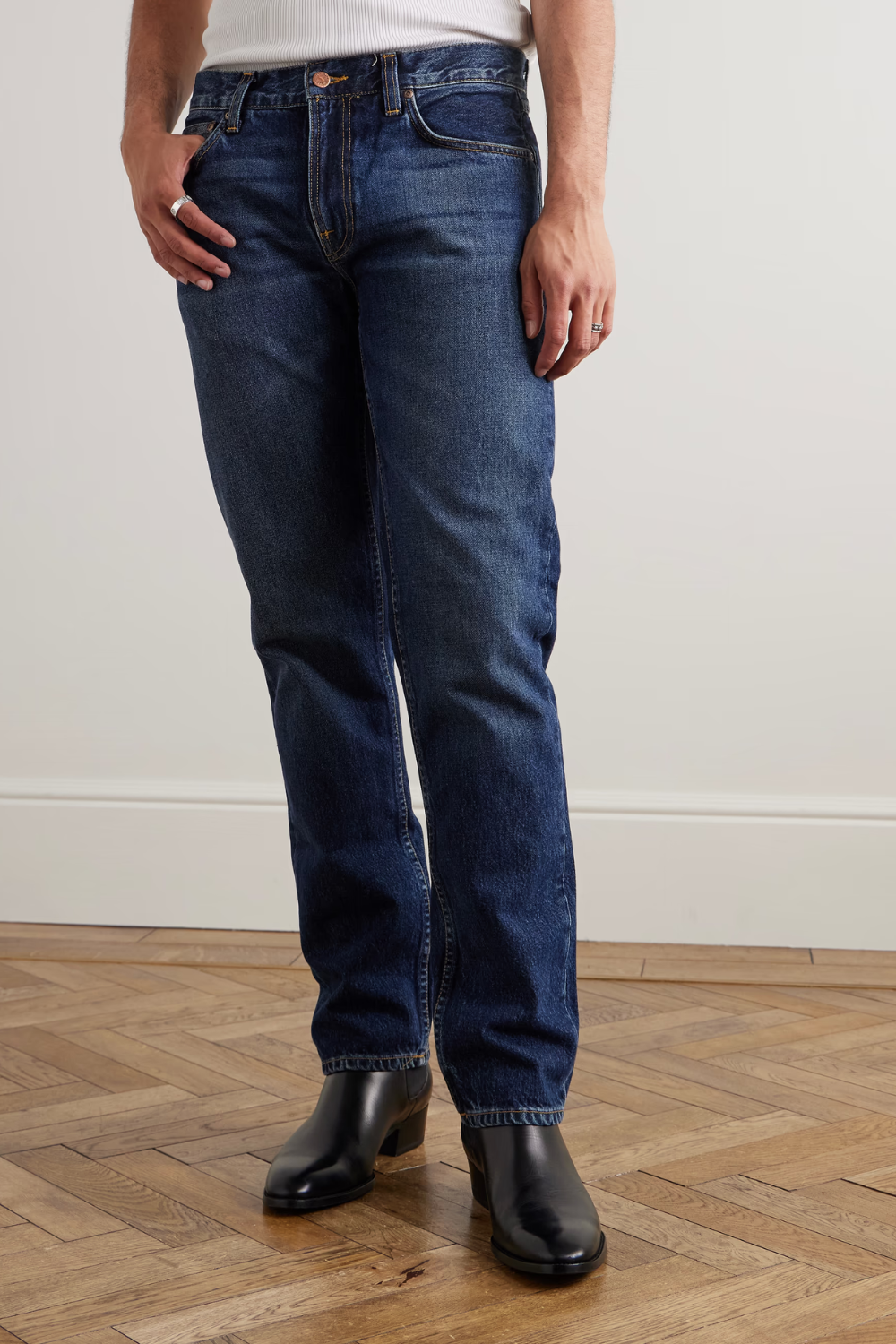 A man wearing Nudie Gritty Jackson Slim-Fit Organic Jeans in blue, shown from the front.