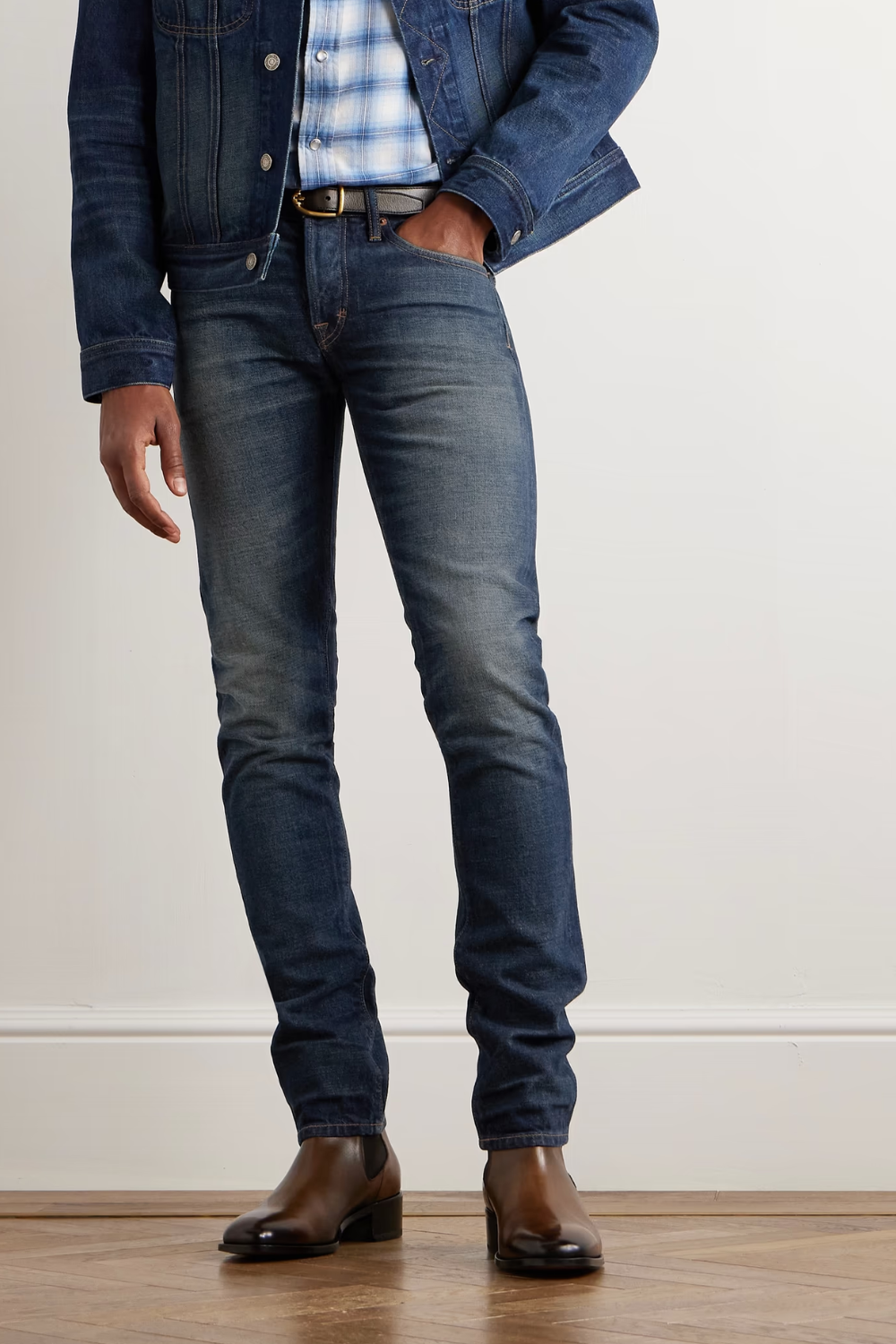 A man wearing Tom Ford Slim-Fit Selvedge Jeans in deep indigo, shown from the front.