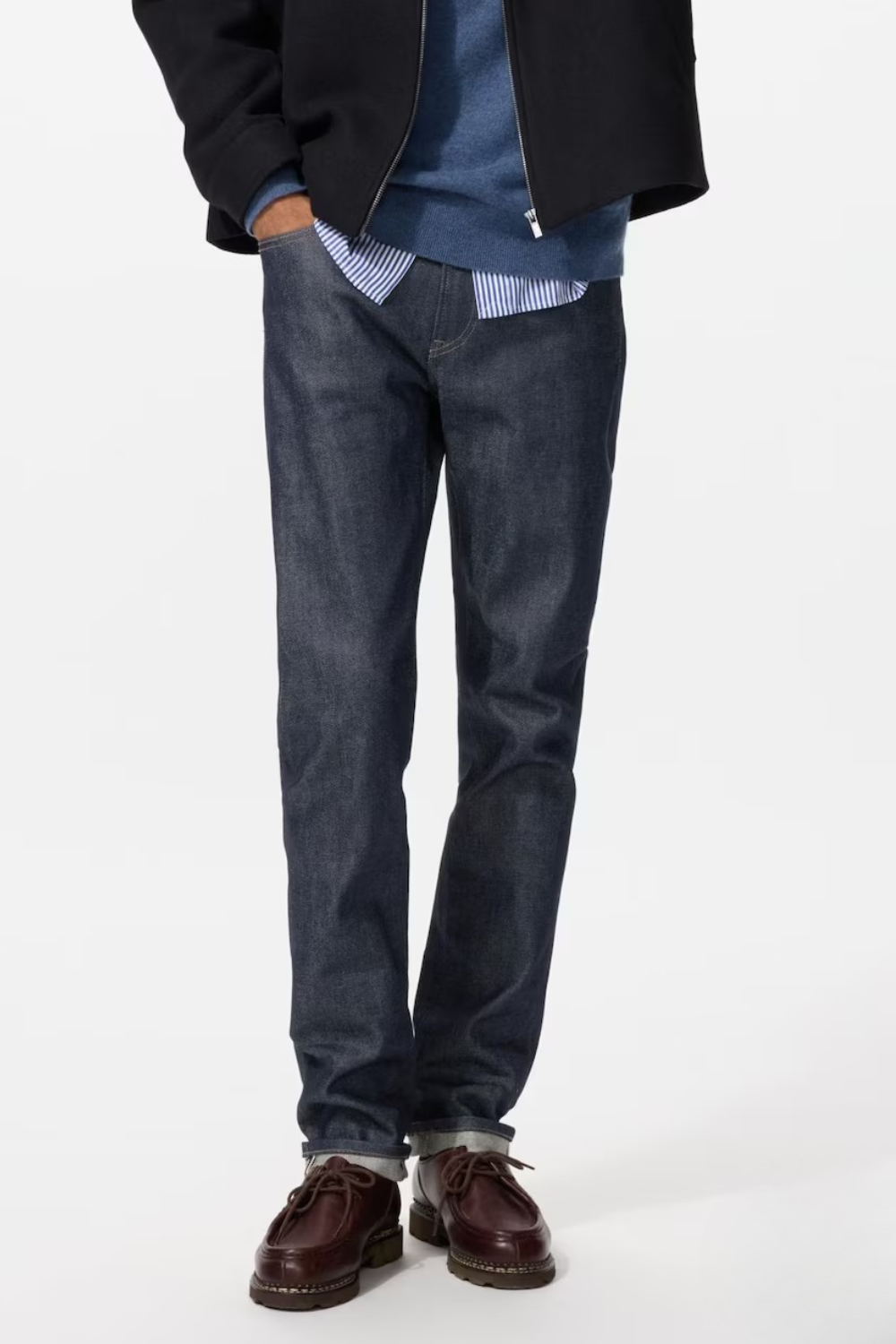 A man wearing Uniqlo Stretch Selvedge Slim Jeans in navy, shown from the front.