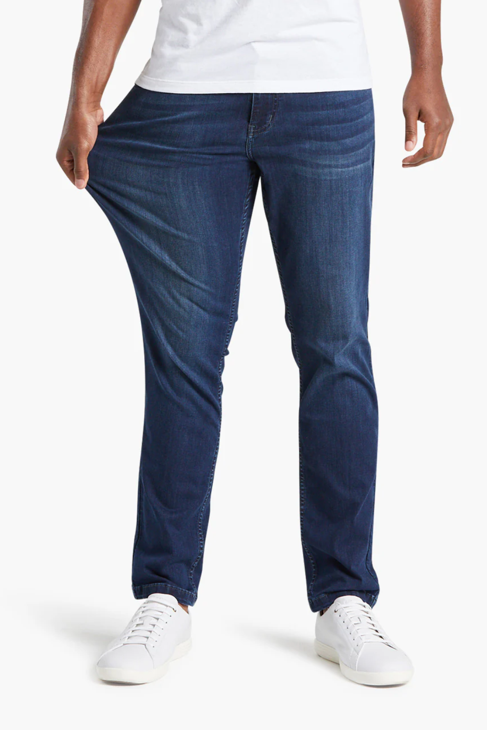 A man stretching Mugsy Fulton Stretch Denim Jeans in blue, shown from the front.