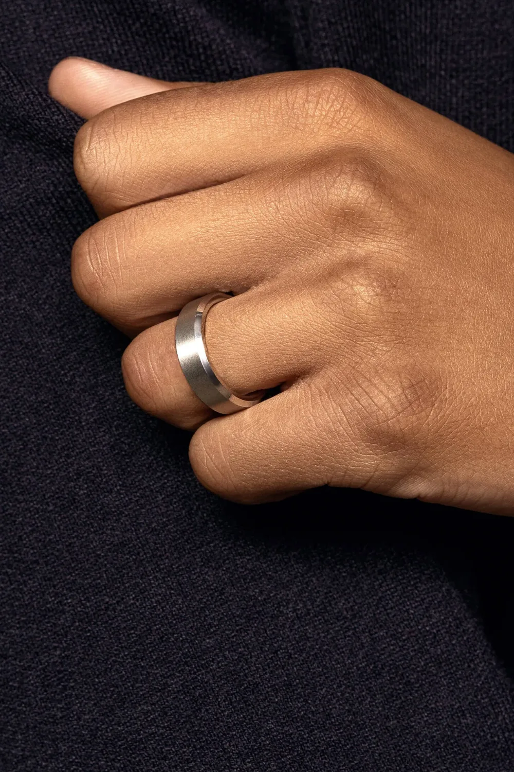 Close-up of a man wearing the Jaxxon Brushed Beveled Edge Band, a minimalist silver ring with a brushed finish and beveled edges.