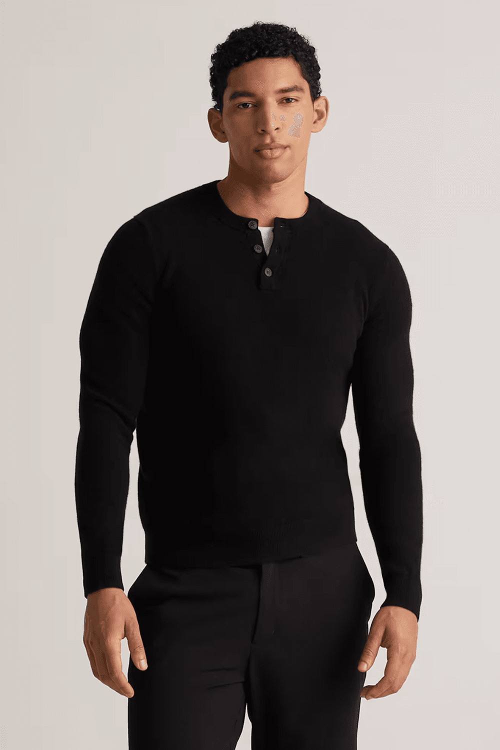 Man wearing Quince Mongolian Cashmere Henley Sweater in black