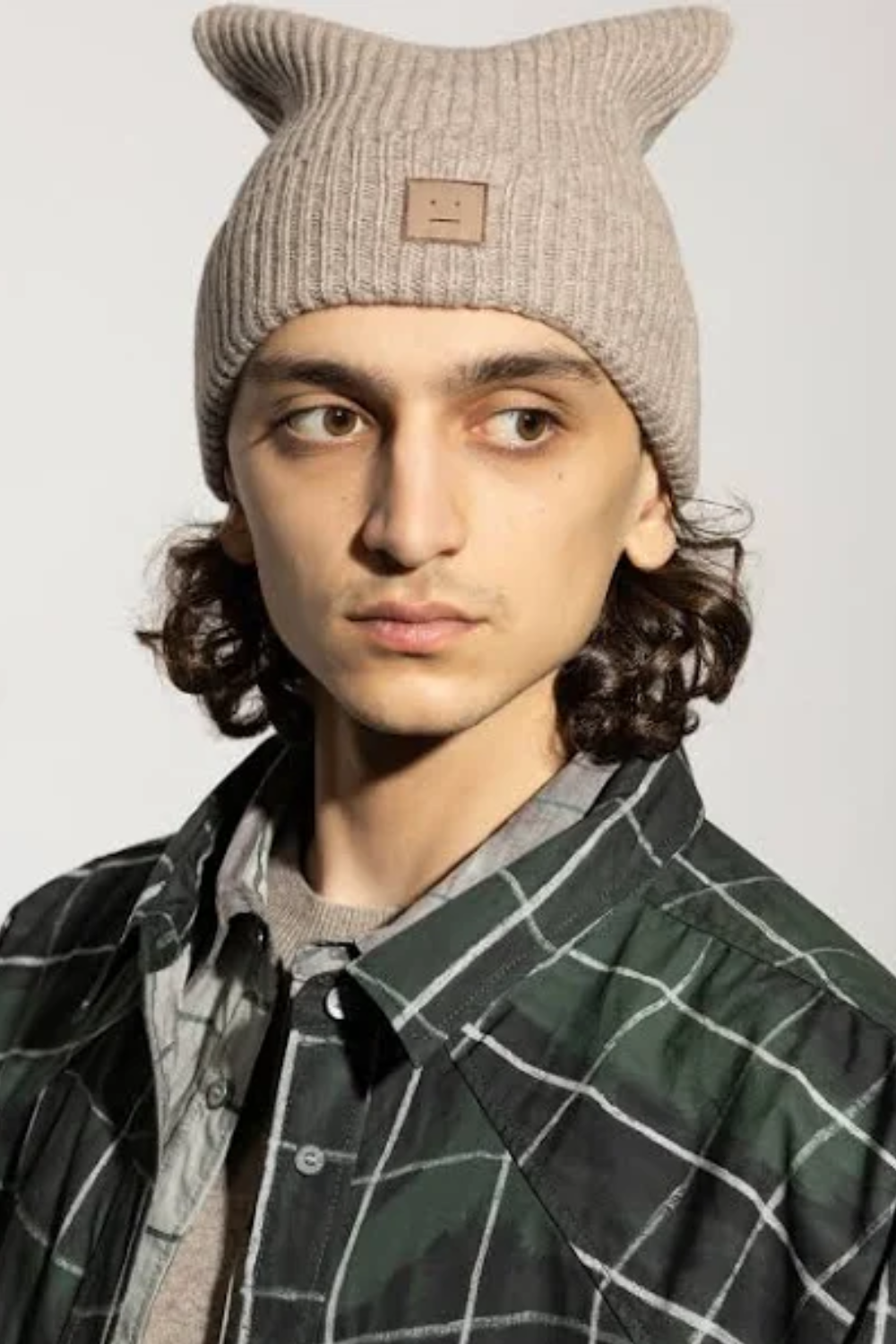 Man Wearing Acne Studios Kua Rib-Knit Beanie in Sand
