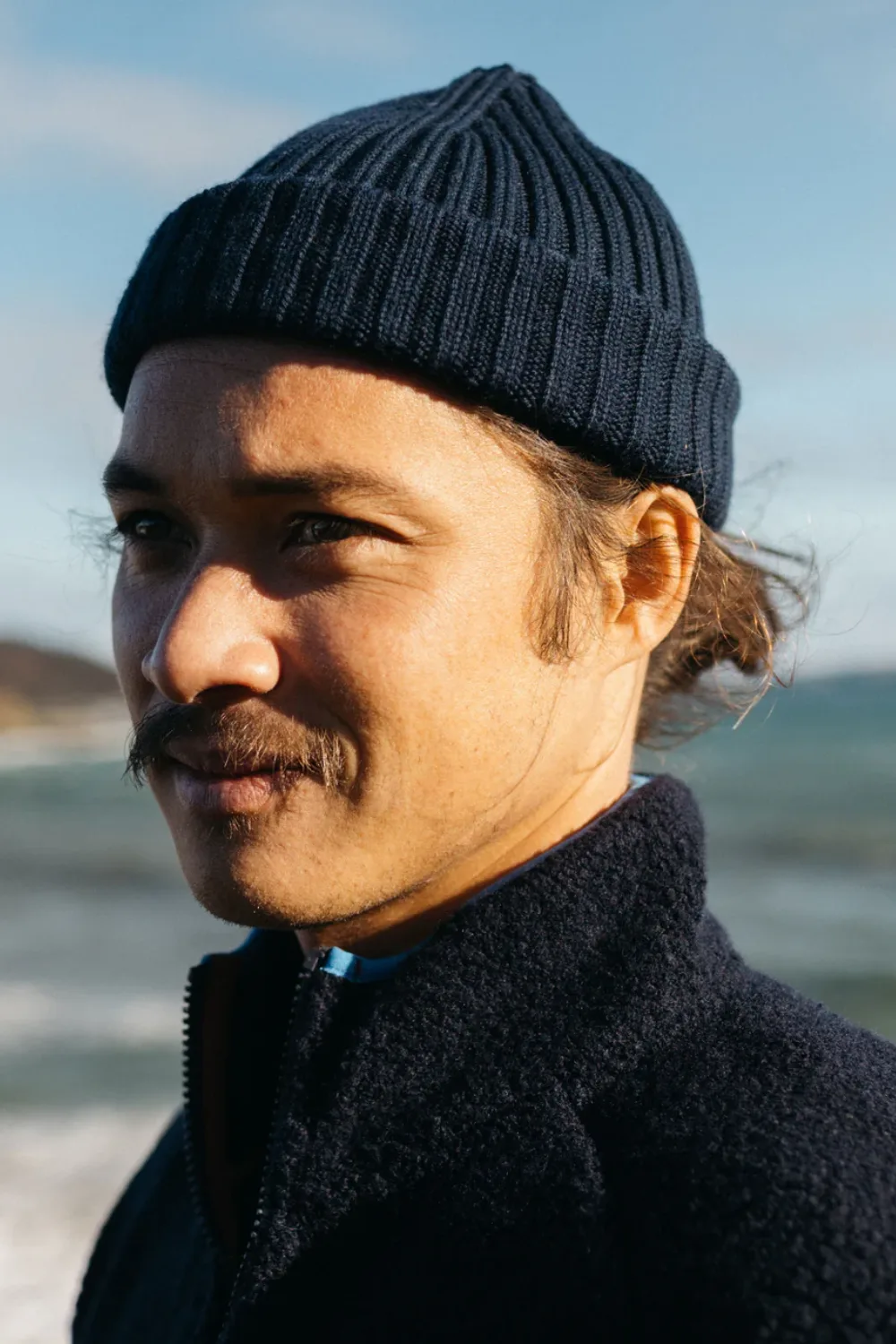 Man Wearing Finisterre Fisherman Beanie in Navy