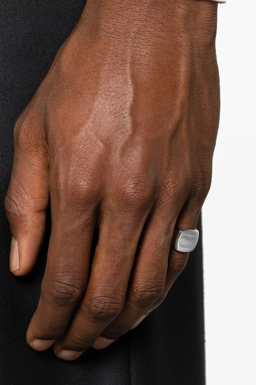 Close-up of the Tom Wood Kay Signet Ring in polished sterling silver, featuring a sleek, reflective surface and minimalist oval top.