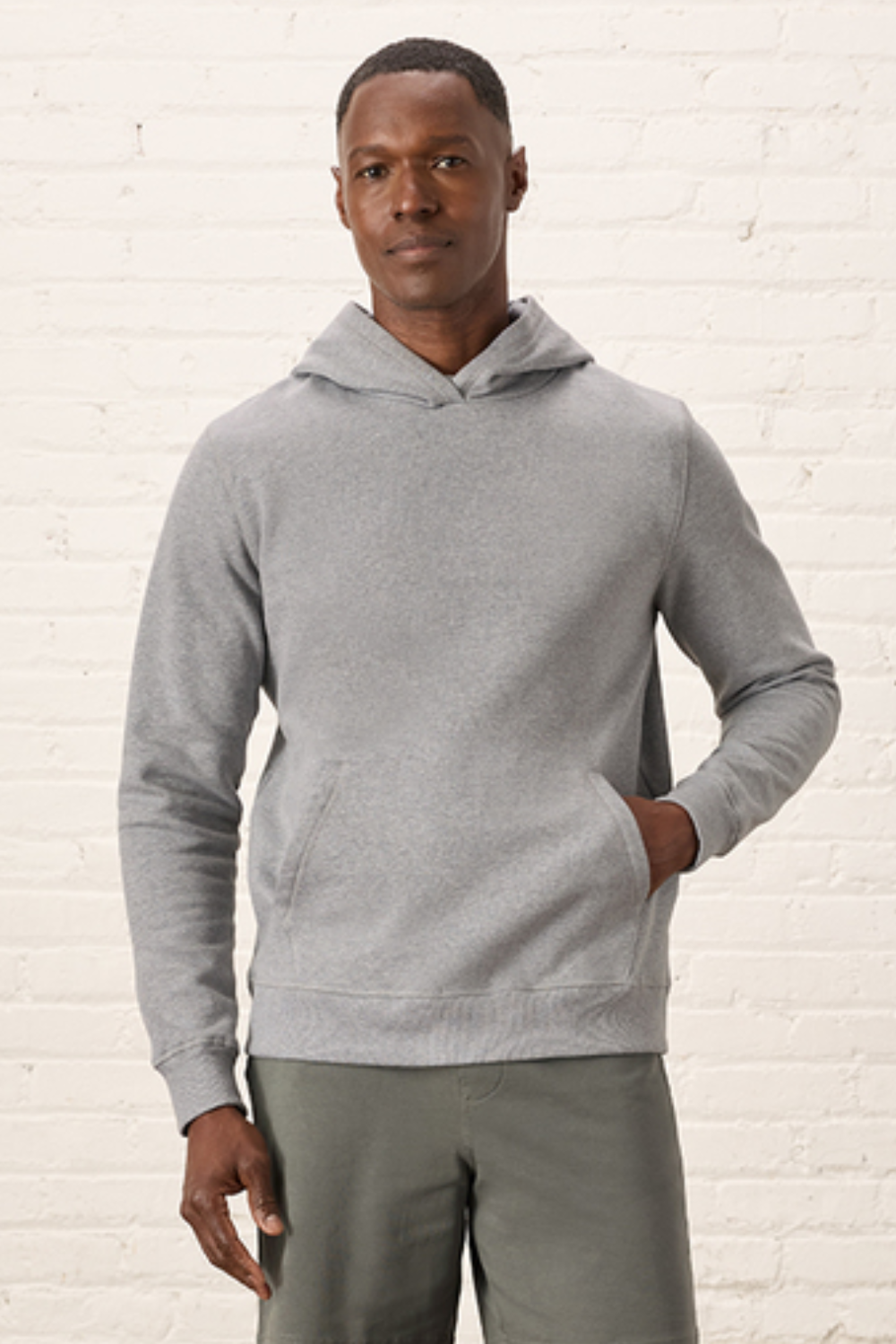 Man Wearing Pact Organic Cotton Hooded Sweatshirt in Gray