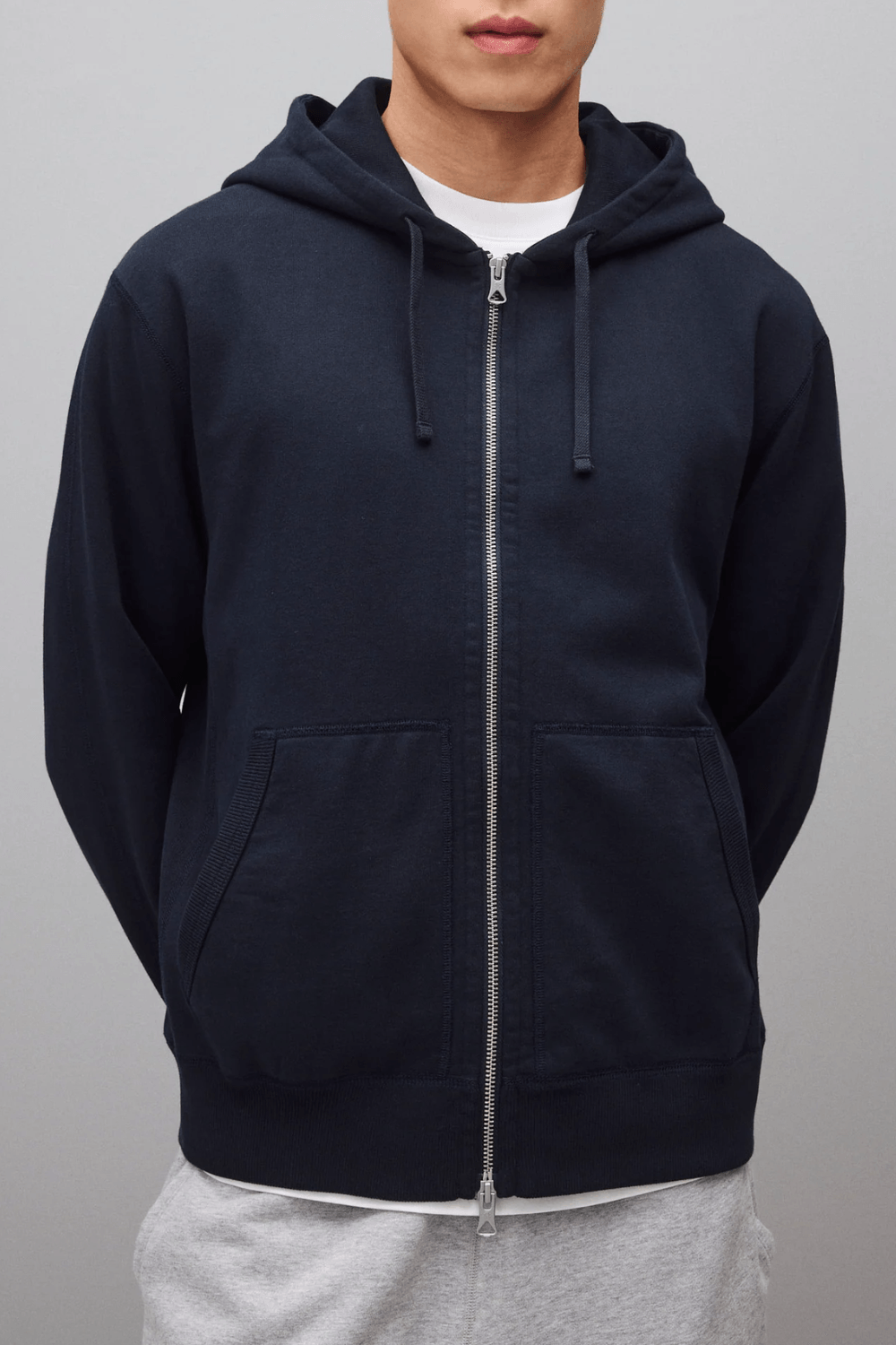 Man Wearing Reigning Champ Midweight Terry Standard Zip Hoodie in Navy