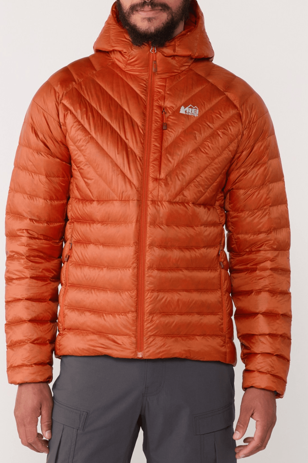 Man Wearing Rei Co-op Men's Magma 850 Down Hoodie in Redrock