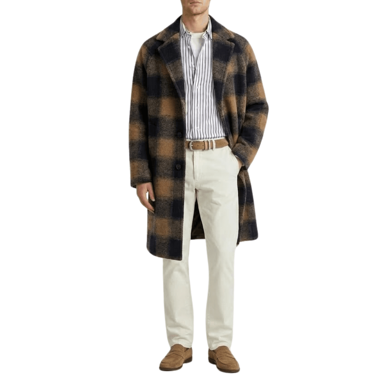 Man wearing a white T-shirt layered under a white cotton poplin shirt with navy vertical stripes, topped with a brown and navy check overcoat, paired with white chinos, brown suede loafers and a matching brown suede belt, standing with one hand in his pocket.