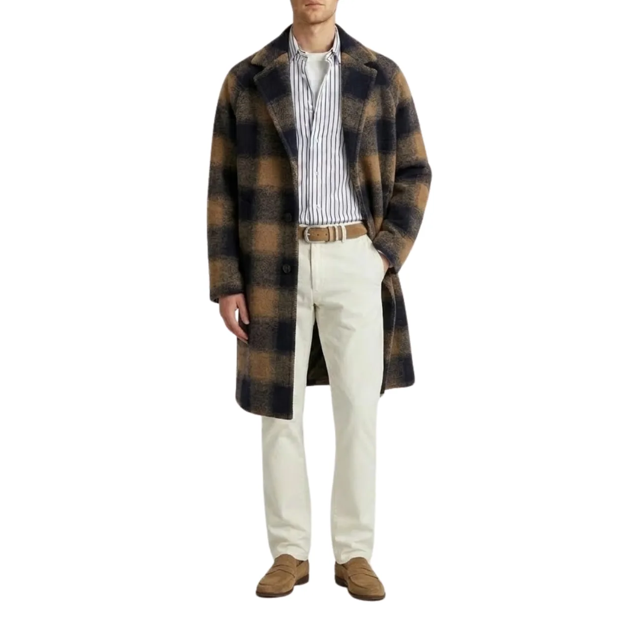 Man wearing a white T-shirt layered under a white cotton poplin shirt with navy vertical stripes, topped with a brown and navy check overcoat, paired with white chinos, brown suede loafers and a matching brown suede belt, standing with one hand in his pocket.