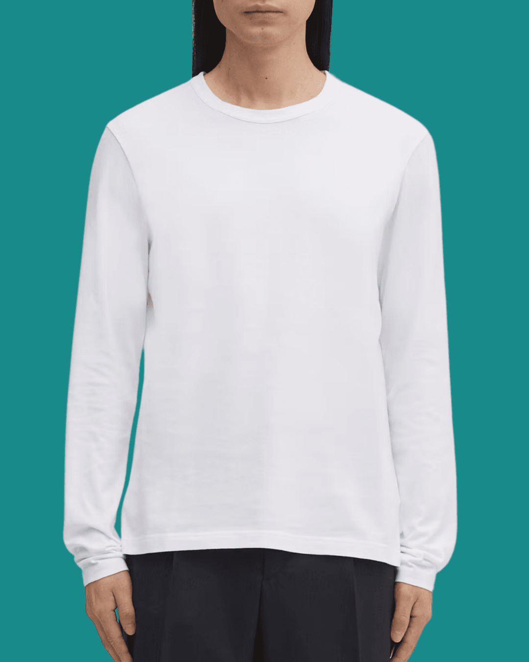 Man wearing Asket The Long Sleeve T-Shirt, standing casually with arms relaxed at his sides.