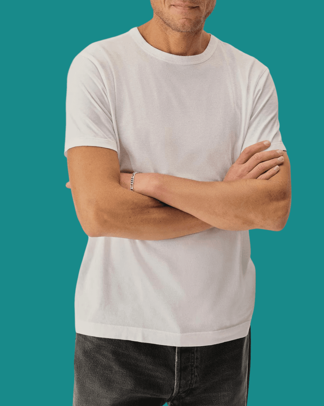 Man wearing Buck Mason Slub Classic White Tee, standing casually with arms crossed.