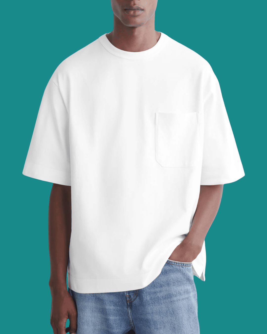 Man in COS Oversized Heavyweight White T‑Shirt with a hand in pockets, standing casually.