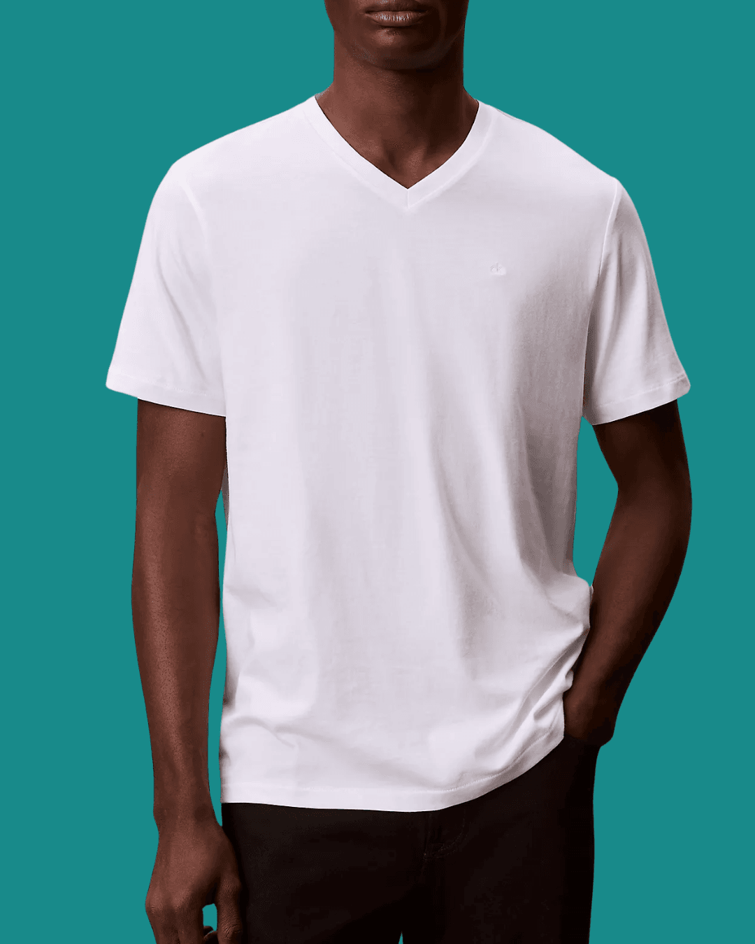 Man in Calvin Klein Liquid Touch Classic V Neck White T-Shirt with a hand in pockets, standing casually.