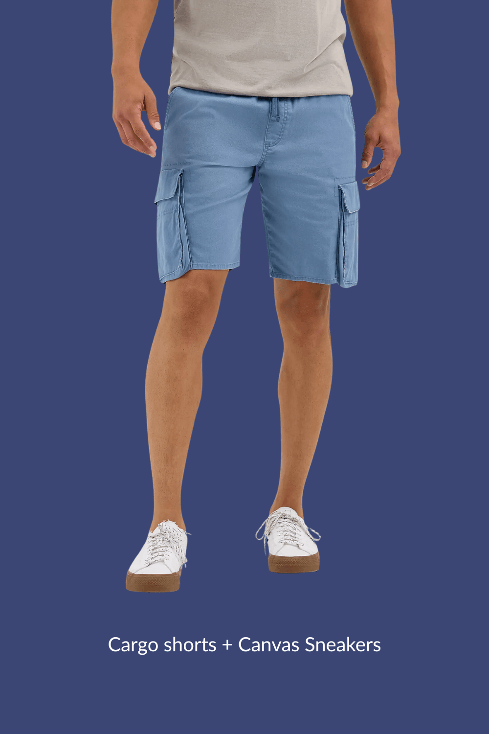 Man wearing blue cargo shorts and white canvas sneakers, standing casually with arms relaxed at sides.