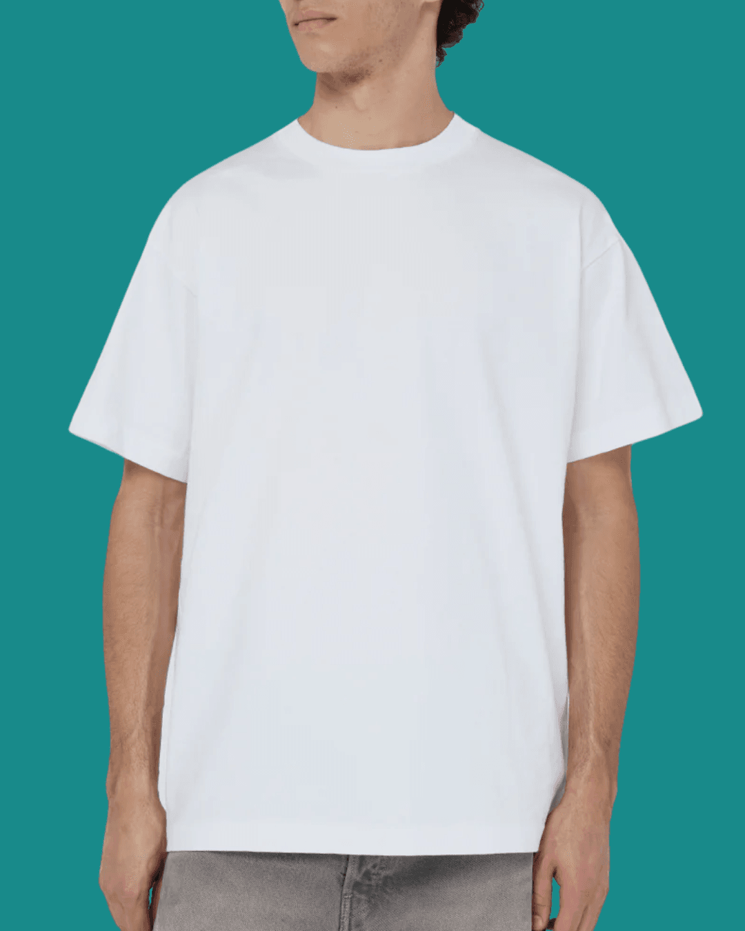 Man wearing John Elliott University White Tee, standing casually with arms relaxed at his sides.
