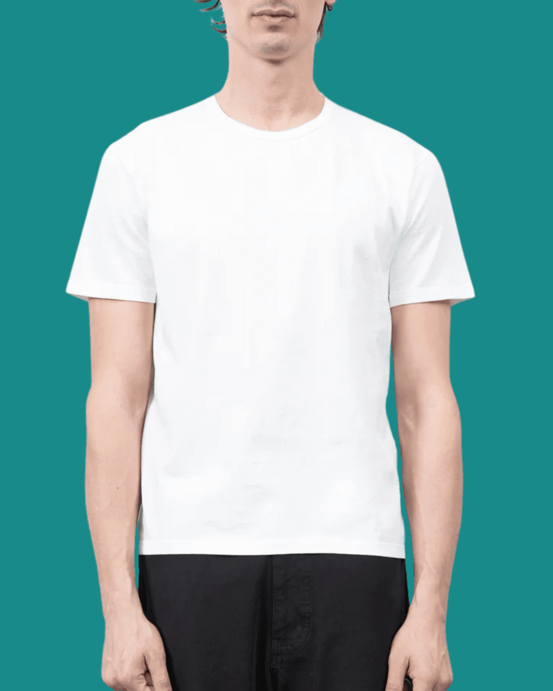 Man wearing Lady White Co. Our T‑Shirt in White, standing casually with arms relaxed at his sides.