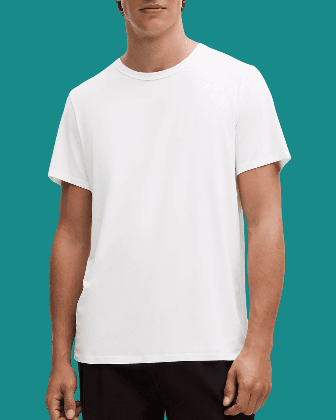 Man wearing Lululemon Fundamental White T-Shirt, standing casually with arms relaxed at his sides.