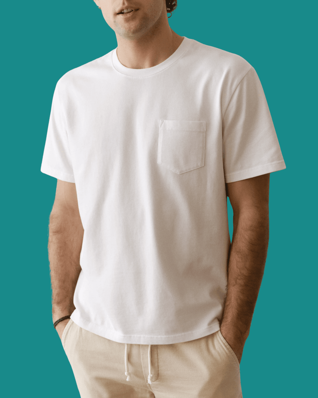 Man in Marine Layer Luxe 250 Relaxed Pocket Tee with hands in pockets, standing casually.