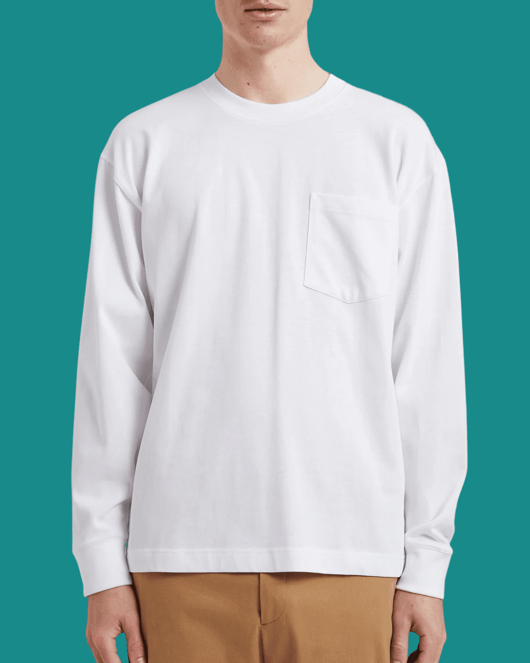 Man wearing Norse Projects Norse Standard Heavy Loose LS White T-shirt, standing casually with arms relaxed at his sides.