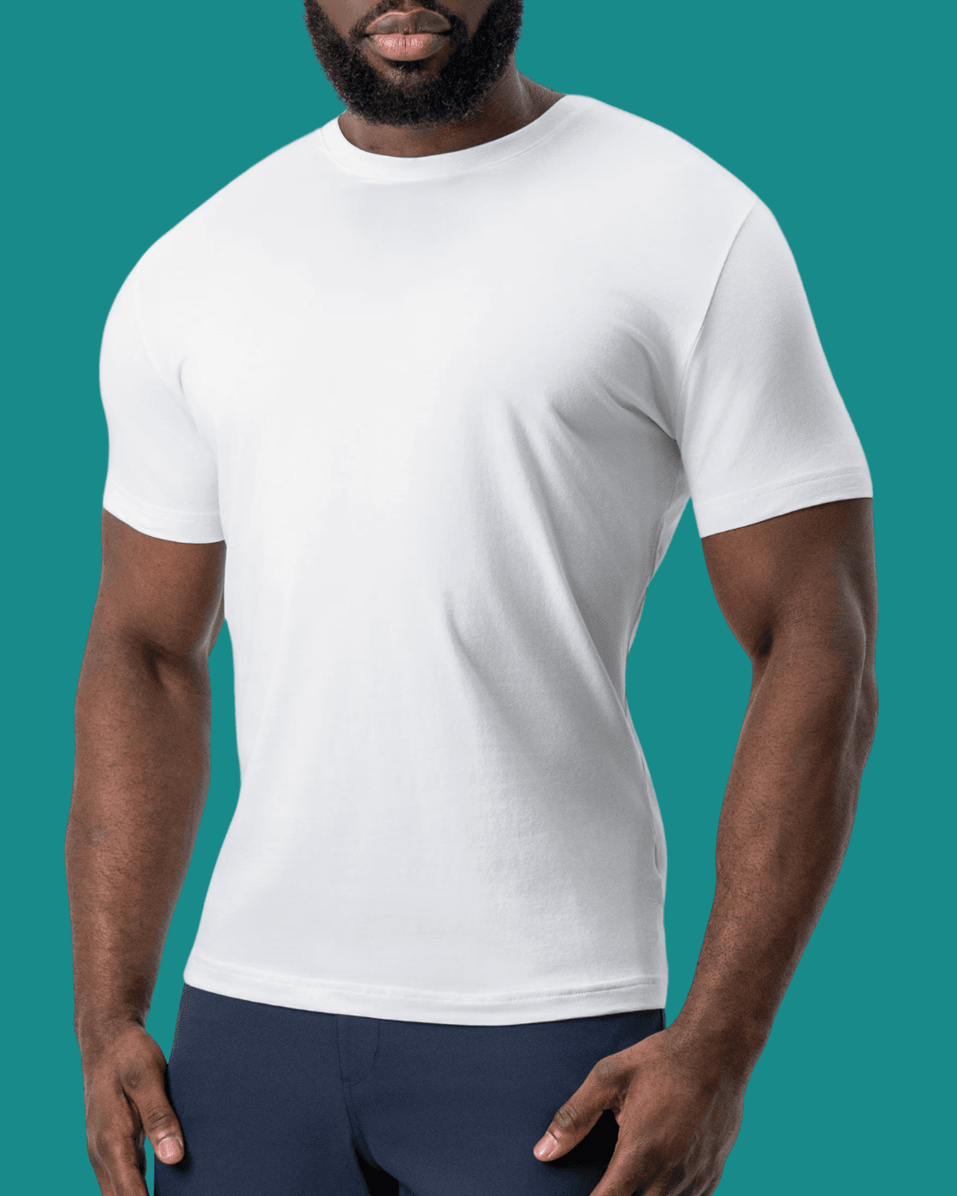 Man wearing State and Liberty The Taylor White Short Sleeve Crewneck, standing casually with arms relaxed at his sides.