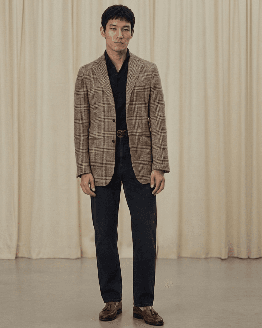 Man wearing tassel loafers with tailored, dark-wash jeans