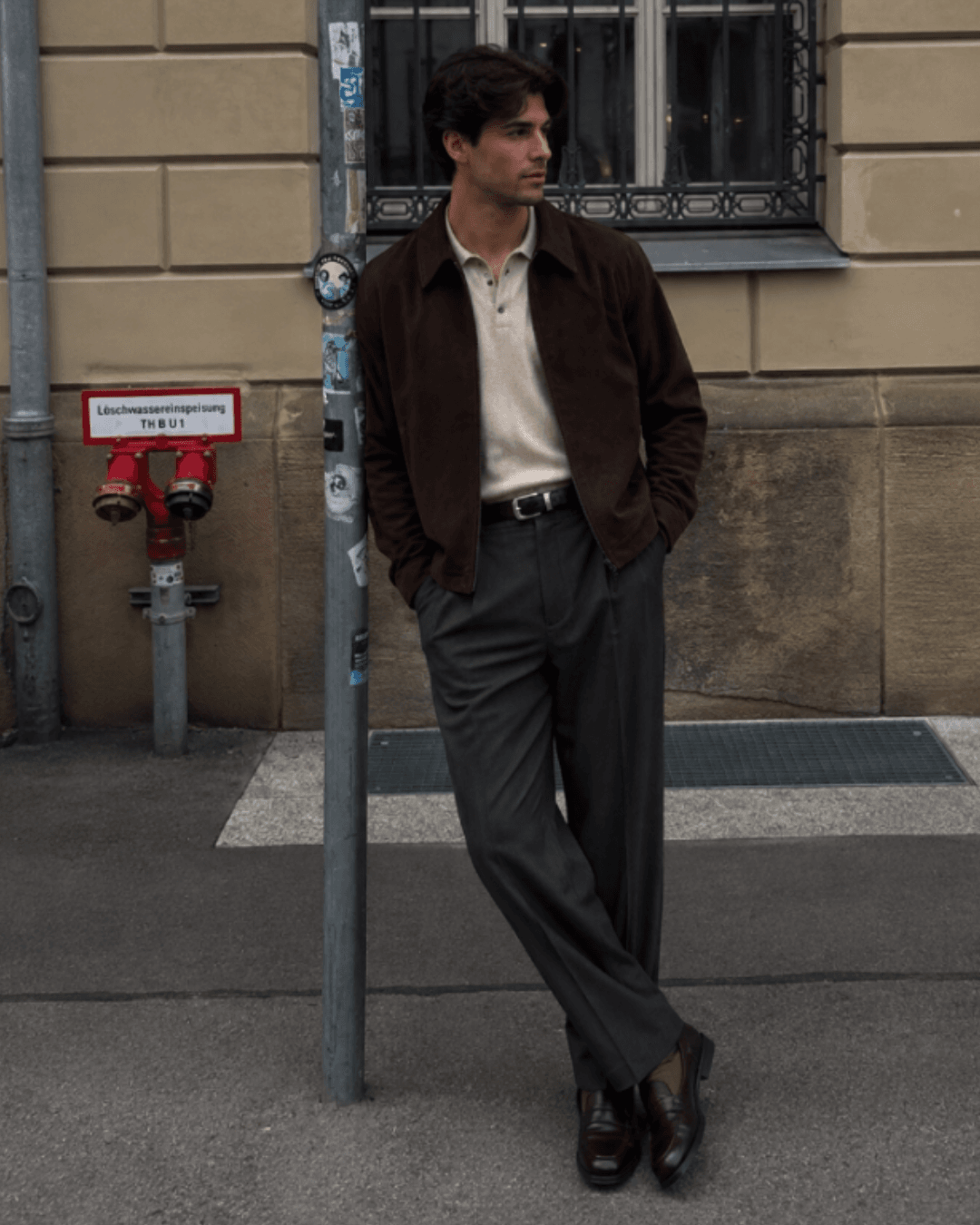 Autumn Date Night Outfit with a dark suede jacket, a fine-gauge knit polo, pleated wool trousers, brown suede loafers