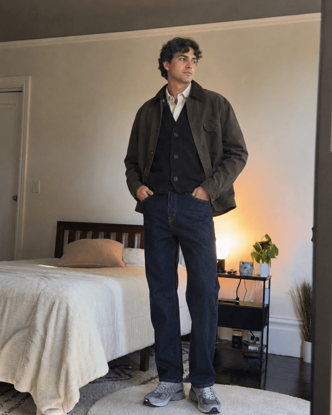 Casual Fall Travel Outfit with a Field jacket, a Knit cardigan, and Oxford shirt, Medium or dark wash jeans, Retro sneakers