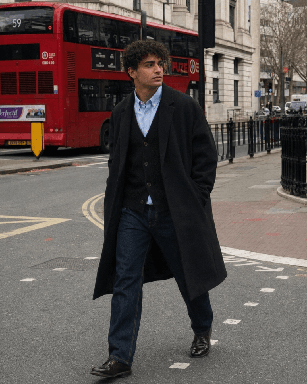 Late Autumn Outfit with a wool topcoat, a knit cardigan, and Oxford shirt, dark-wash jeans, and leather Derbies