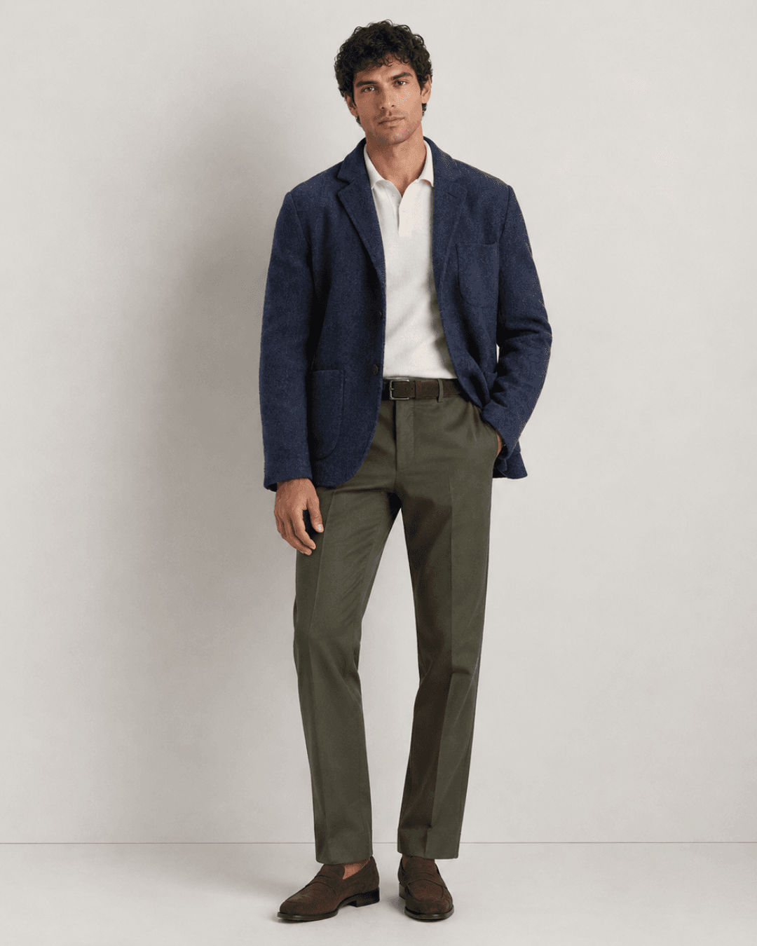 Man wearing a Slate-blue wool blazer, an Off-white knit polo, Olive trousers, and Chocolate brown suede loafers