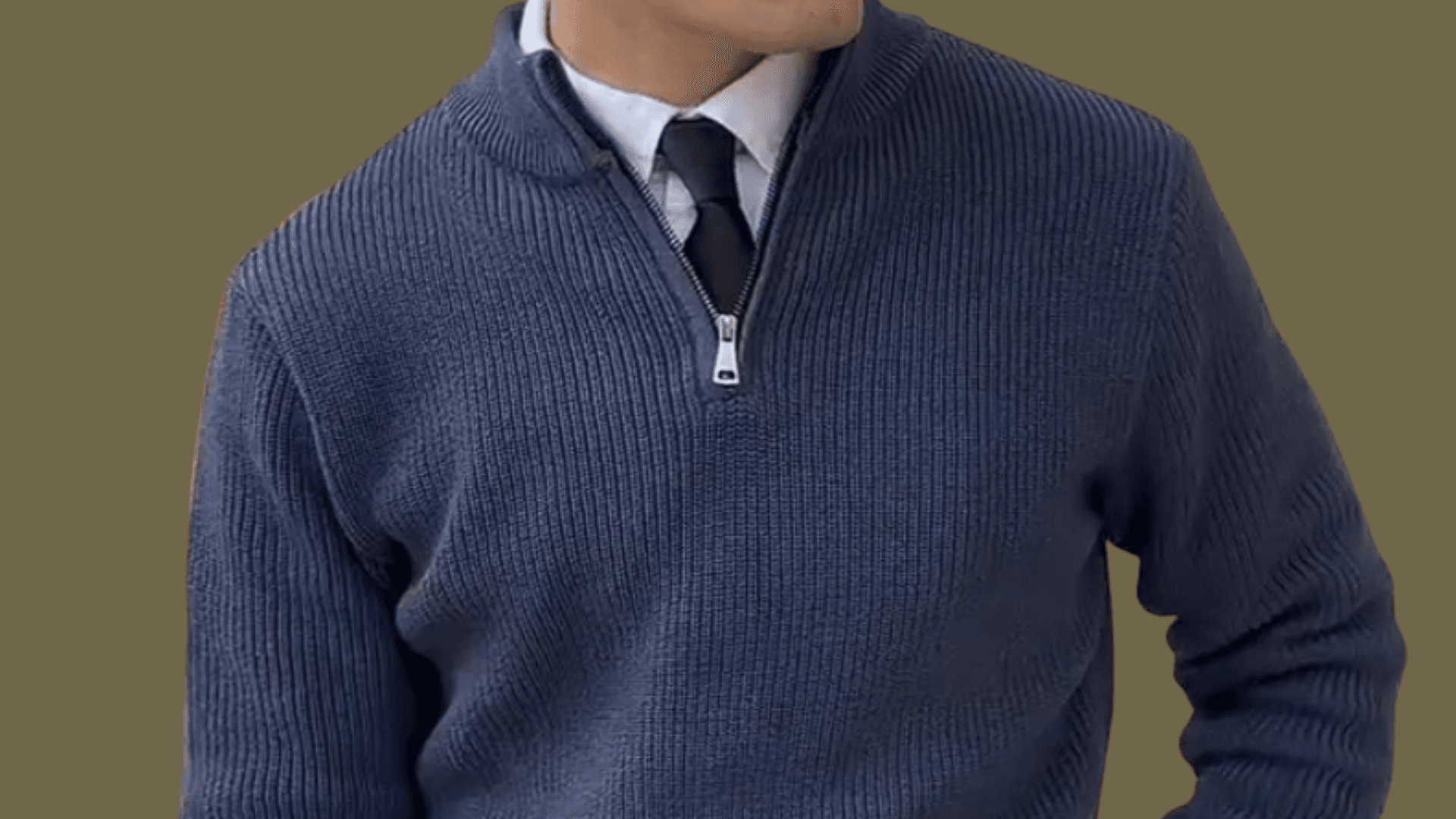 man wearing a half-zip sweater, a white Oxford shirt with a tie